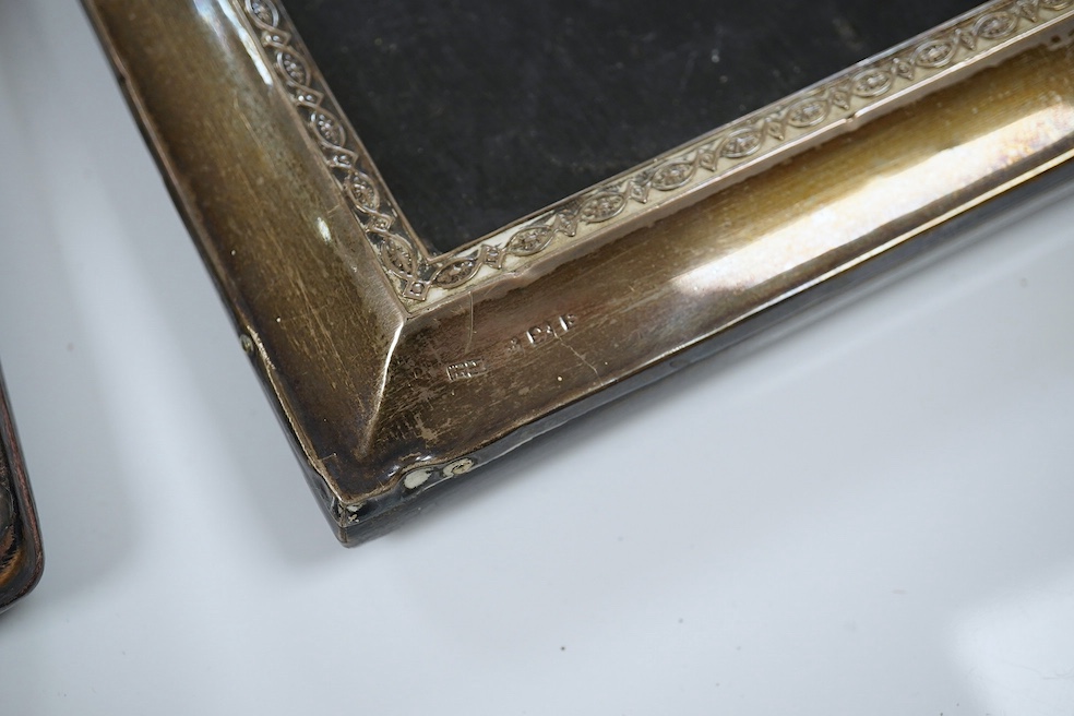 A late Victorian repousse silver mounted rectangular easel mirror, Birmingham, 1900, 26.8cm, together with a pair of George V silver mounted rectangular photograph frames, Birmingham, 1917. Condition - poor